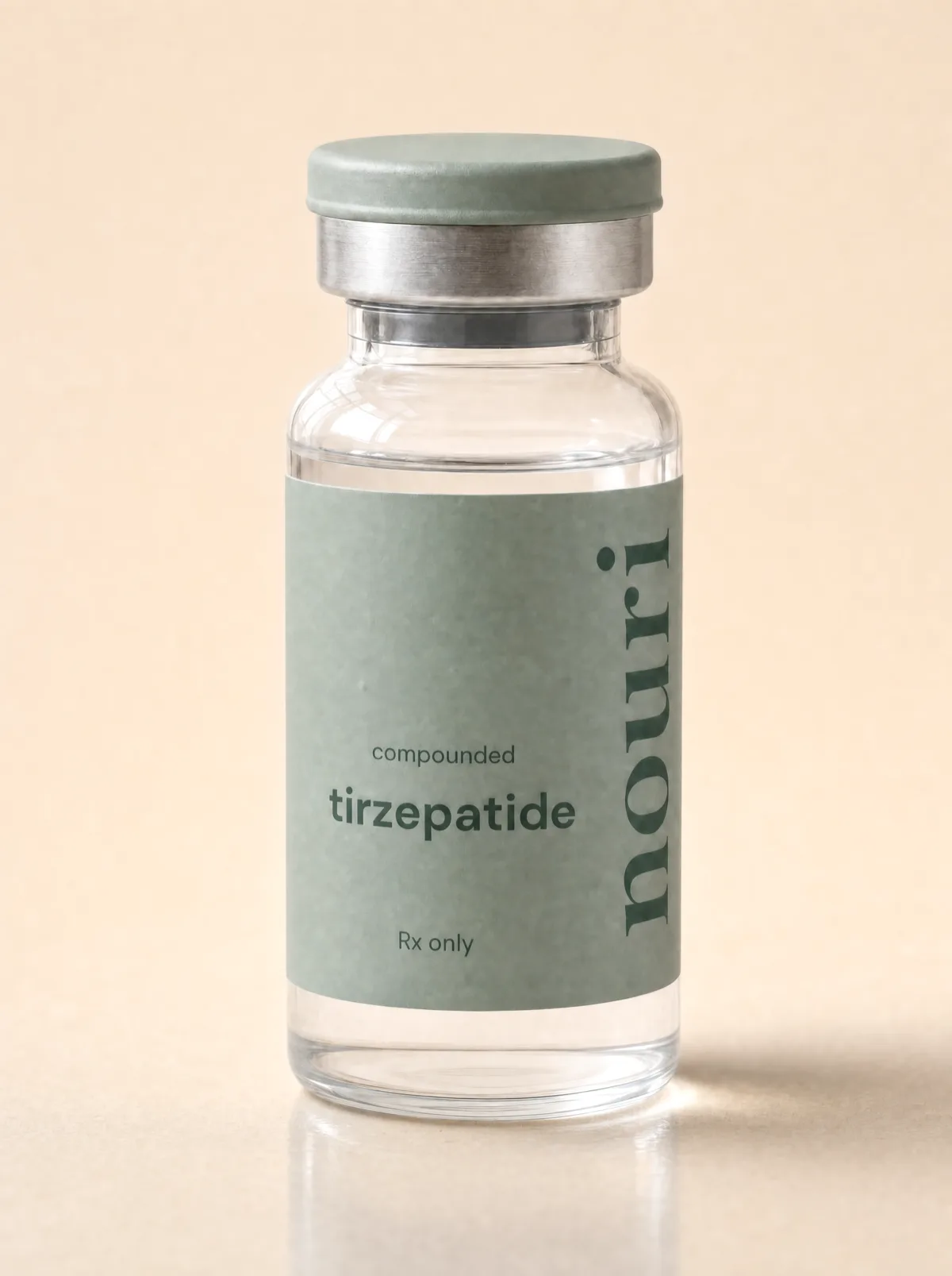 A vial of Nouri compounded tirzepatide with a sage-green Rx-only label on a warm beige background - a tirzepatide compound prescribed online.